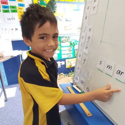 Child Pointing at Whiteboard