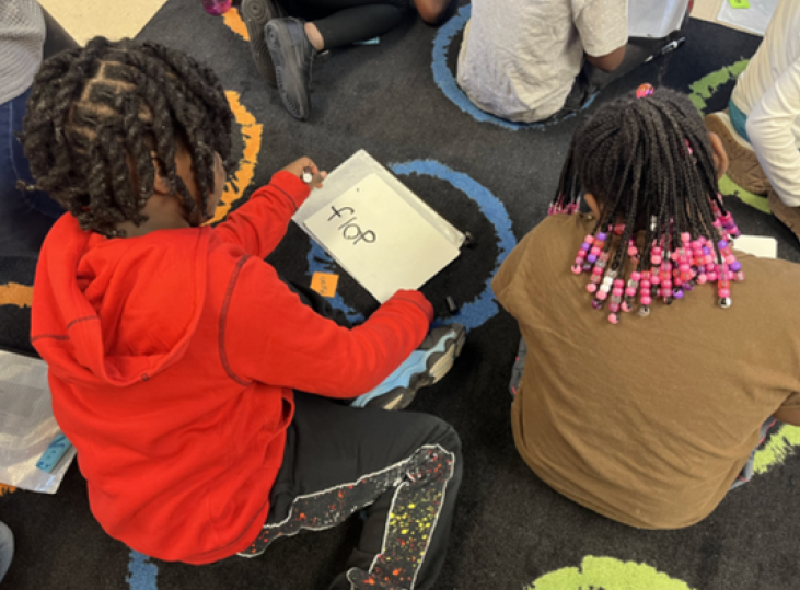 Child Pointing at Whiteboard