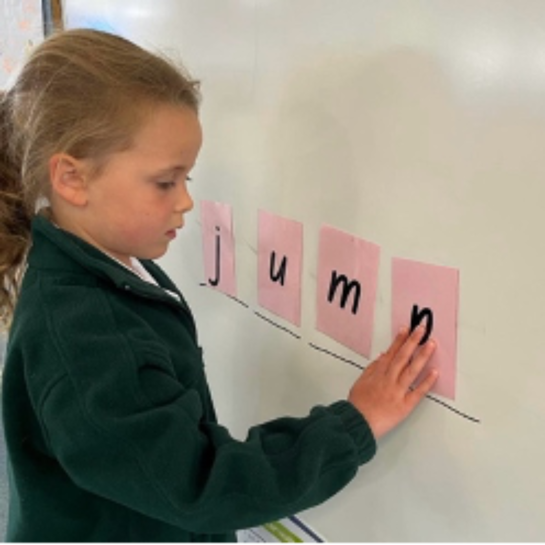 Child Pointing at Whiteboard