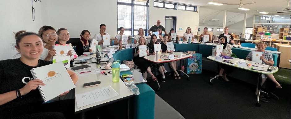 A photo of 16 Sounds-Write trainees in Sydney smiling at the camera.