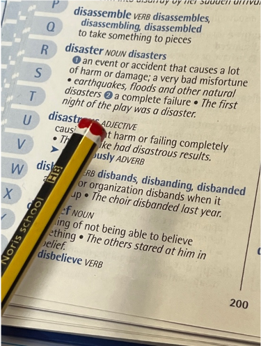 A dictionary: an invaluable learning tool. Showing the definition for disaster and disastrous.