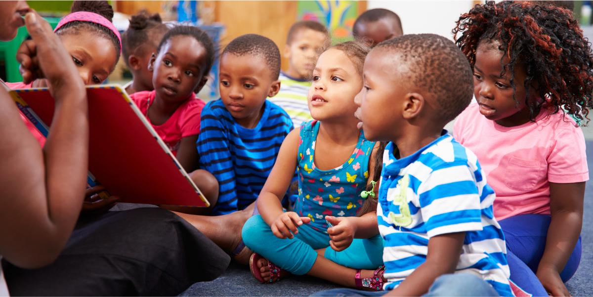 Build Phonological & Phonemic Awareness Teacher showing a book to children