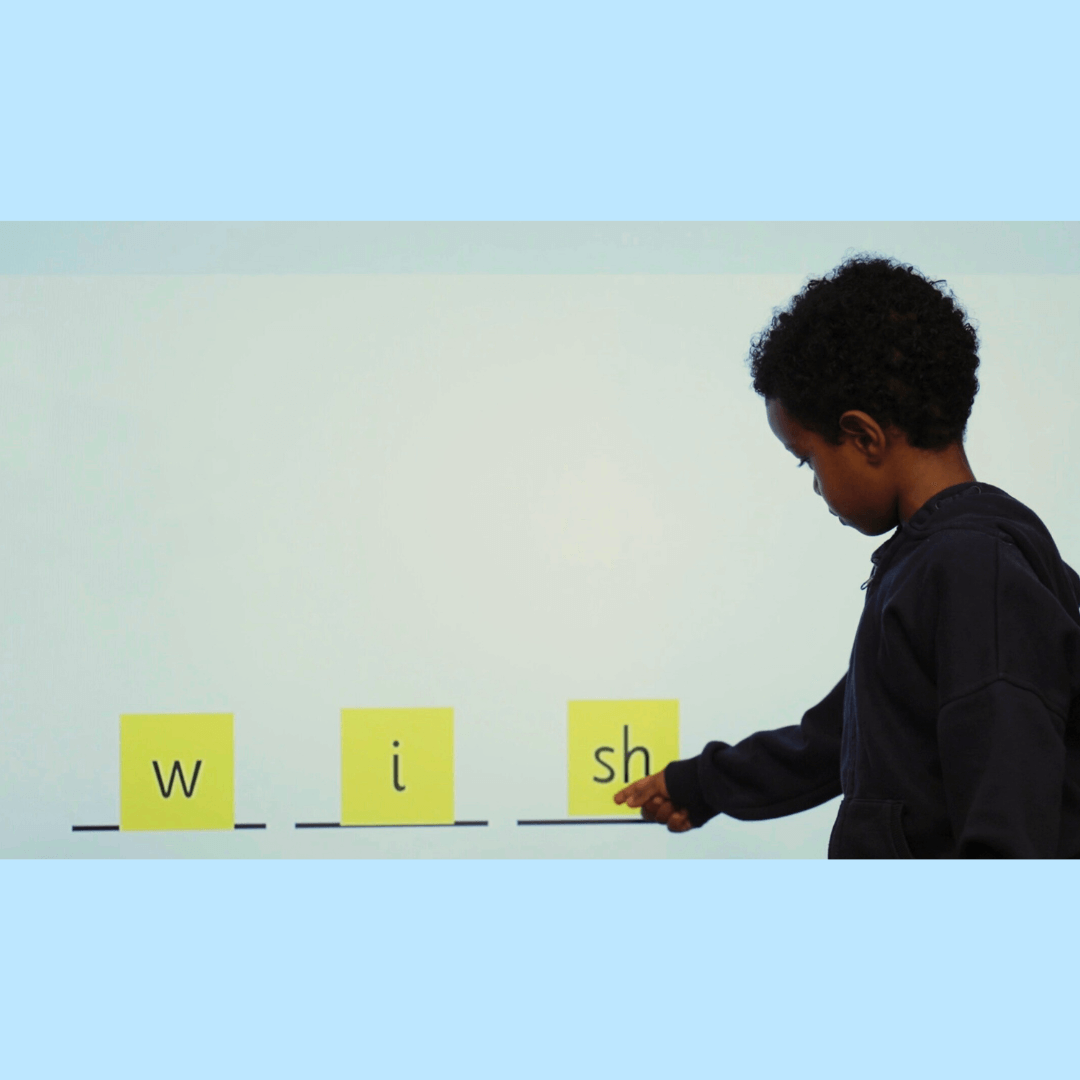 Boy engaged in phonics activity.