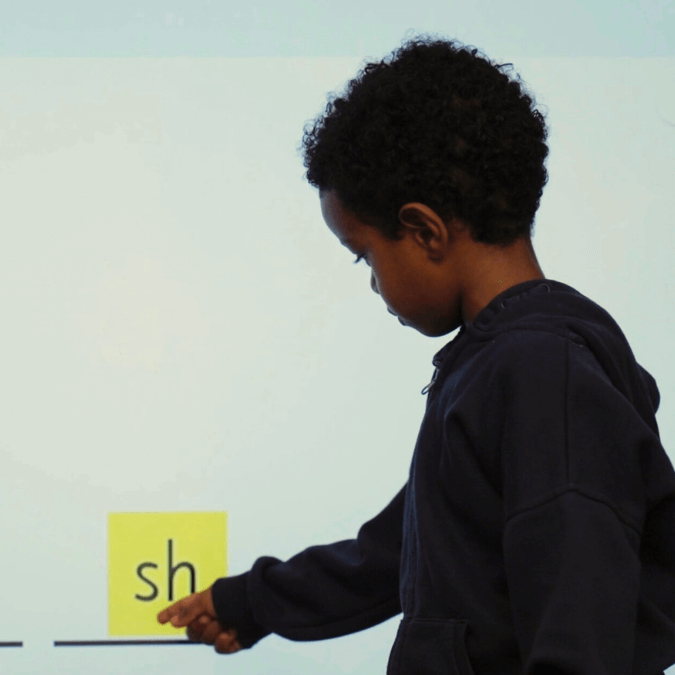 Boy engaging in phonics activity
