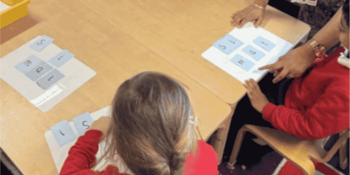 Girl making word with cards