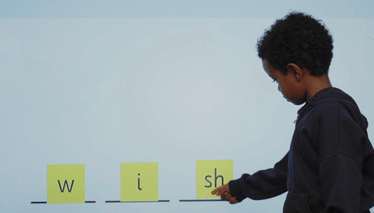 Boy pointing to the sound 'sh'