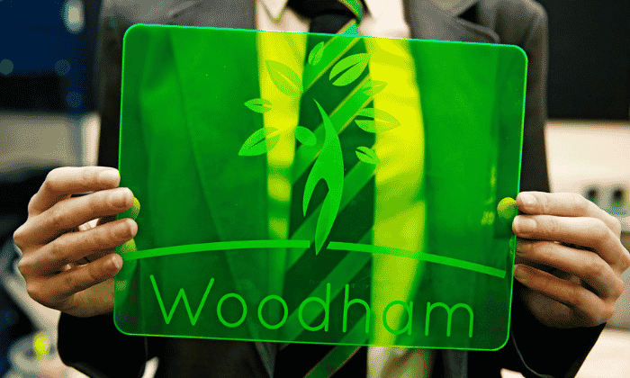 Student holding Woodham logo