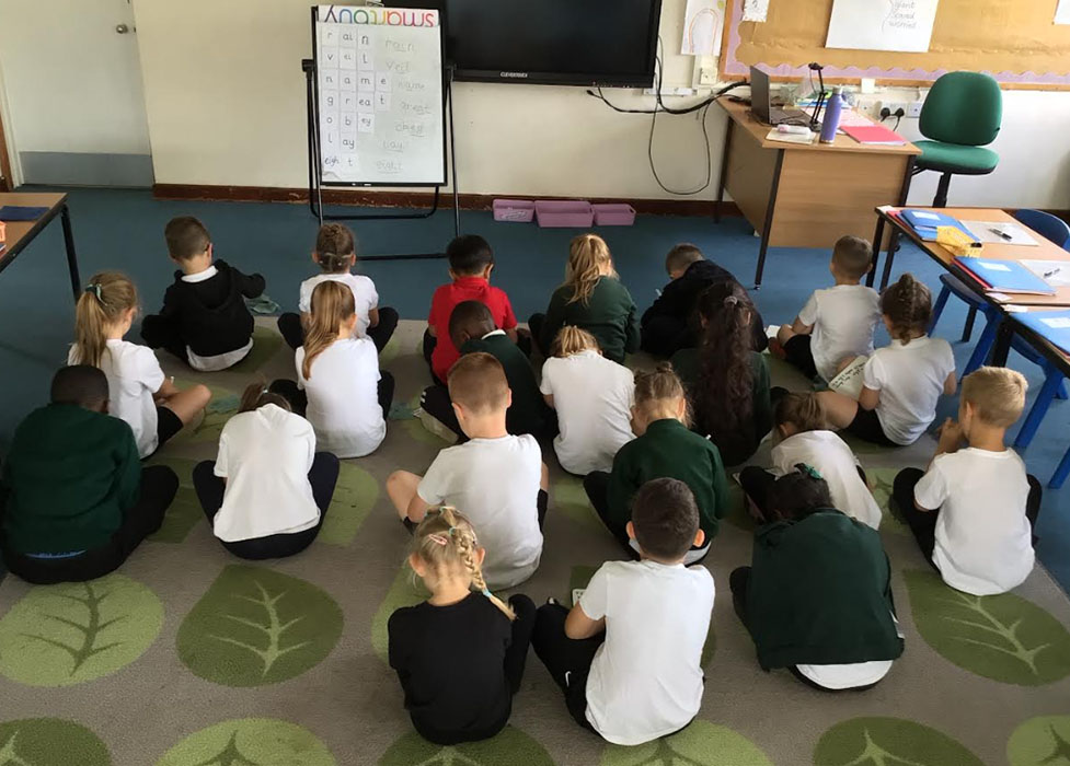 Children in classroom during phonics lesson